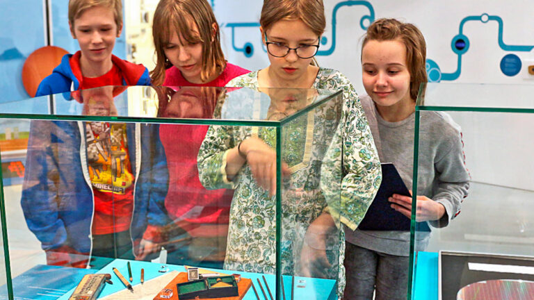 Koululaisia Tekniikan museon näyttelyssä tutkimassa museoesineitä