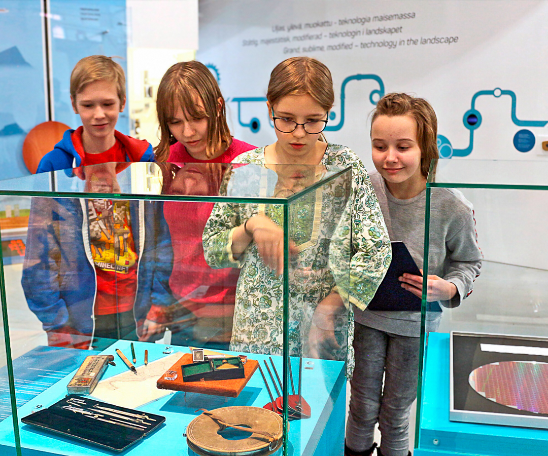 Koululaisia Tekniikan museon näyttelyssä tutkimassa museoesineitä